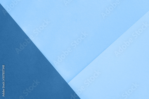 Blue paper background. Geometric figures, shapes. Abstract geometric flat composition. Trendy color of the year 2020.