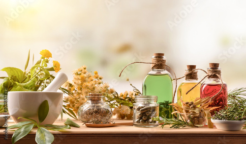 Composition of natural alternative medicine with capsules essence and plants photo