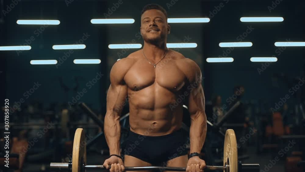 Bodybuilder handsome strong athletic man pumping up biceps muscles workout fitness and bodybuilding concept background - muscular fitness men doing arms exercises in gym naked torso Bodybuilder handsome strong athletic man pumping up biceps muscles workout fitness and bodybuilding concept background - muscular fitness men doing arms exercises in gym naked torso