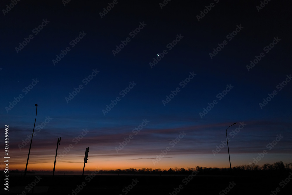 Naklejka premium Dawn on an empty road at five o'clock in the morning