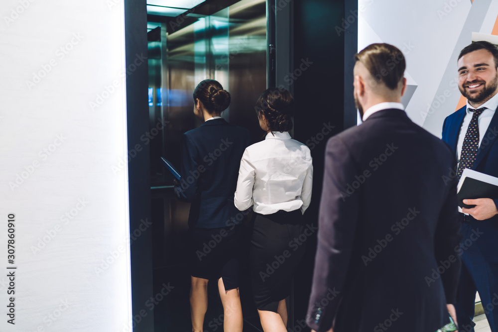 Group of businesspeople entering elevator Group of businesspeople entering elevator