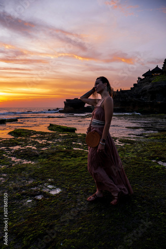 Woman against Pura Tanah Lot temple , Bali
