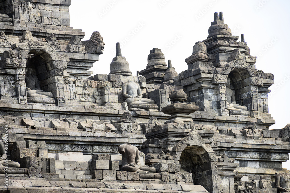 (Selective focus) Stunning view of the Borobudur Temple decorated with beautiful relief panels and Buddha statues. Borobudur is a Mahayana Buddhist temple in Central Java, Indonesia.