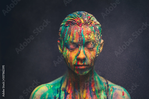 Schilderij op canvas Young woman covered with a colourful paint