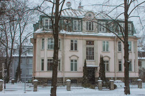 Snowfall in Tallinn. Historic house on the street in winter season. Estonia