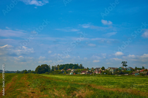 Peaceful rural summer european landscape with green trees and water
