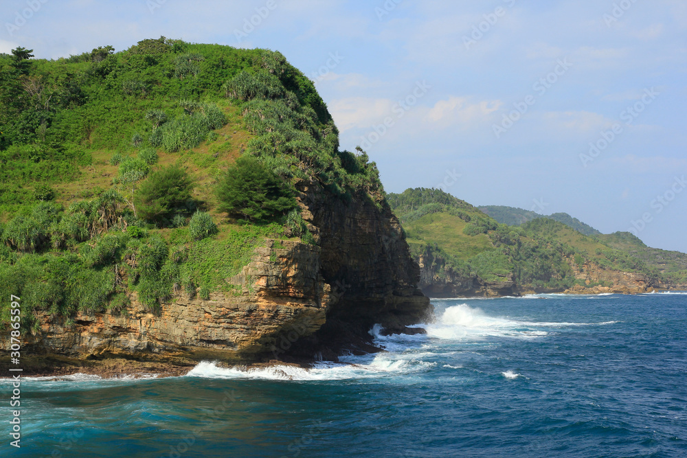 Clusters of cliffs on the towering beach of Gunungkidul meet with strong Indian Ocean waves