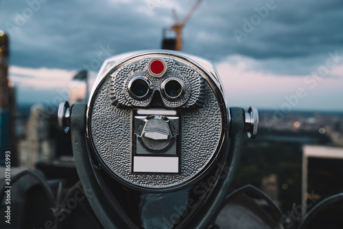 Binoculars on rooftop at evening