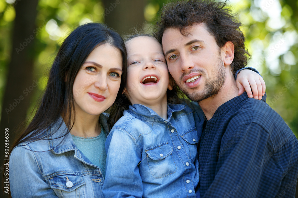Family life. Portrait of parents and their daughter on the background of nature. Family life. Portrait of parents and their daughter on the background of nature.