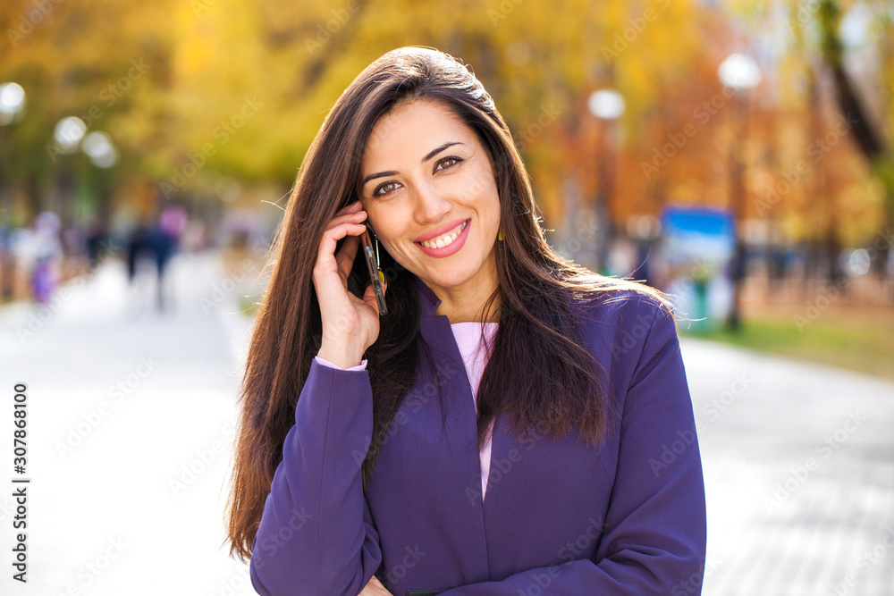 Portrait of a young beautiful model calling by smart phone Portrait of a young beautiful model calling by smart phone