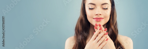 Beautiful model woman with pink manicure nails on blue banner background