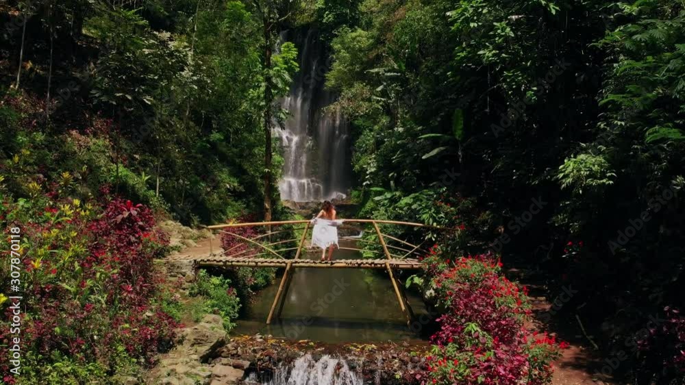 Woman near Labuhan Kebo Waterfall located in Munduk, Bali Woman near Labuhan Kebo Waterfall located in Munduk, Bali