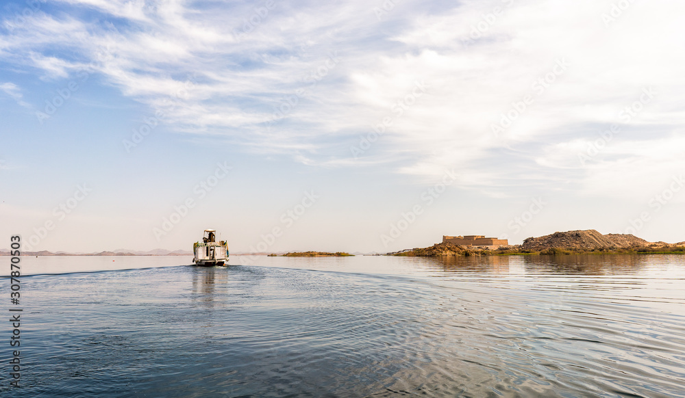 Fototapeta premium boat sailing in nasser lake old egypt temple kalabsha