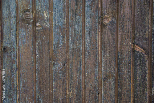 Brown wooden wall with blue paint, old wood planks texture, grunge background, abstract interior design 