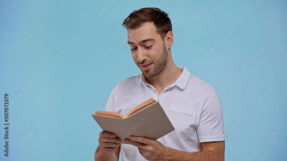 smiling man reading book isolated on blue smiling man reading book isolated on blue