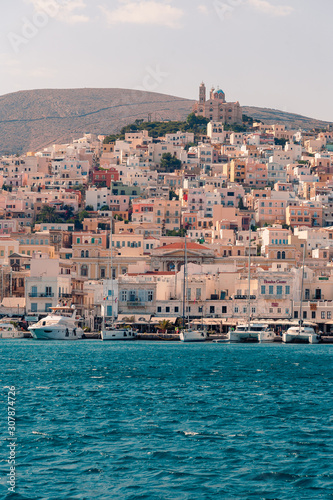 Fototapeta Naklejka Na Ścianę i Meble -  SYROS, GREECE - JUNE 26, 2019: casual from city port side streets and building at summer time