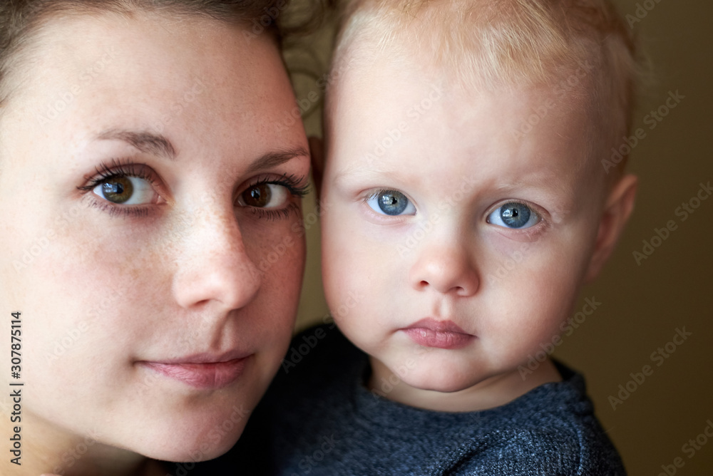 Portrait of a mother with brown eyes and her little son with blue eyes. Portrait of a mother with brown eyes and her little son with blue eyes.