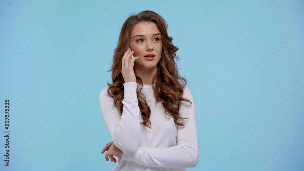woman talking on smartphone isolated on blue woman talking on smartphone isolated on blue