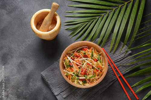 Delicious Som Tam -Thai green papaya salad) with green beans, tomatoes, peanuts. Thai street food . Healthy vegan foodgreen beans, tomatoes, peanuts. Thai street food . Healthy vegan food photo