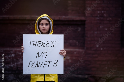 Teenager girl holding placard during global strike for climate change      photo