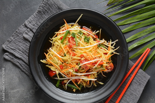 Delicious Som Tam -Thai green papaya salad) with green beans, tomatoes, peanuts. Thai street food . Healthy vegan foodgreen beans, tomatoes, peanuts. Thai street food . Healthy vegan food photo