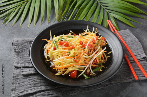 Delicious Som Tam -Thai green papaya salad) with green beans, tomatoes, peanuts. Thai street food . Healthy vegan foodgreen beans, tomatoes, peanuts. Thai street food . Healthy vegan food photo