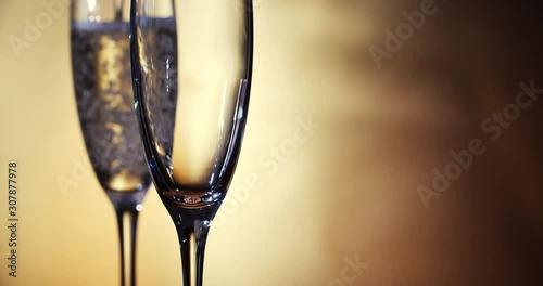 Champagne is poured into the glasses. Slow motion. 4K.