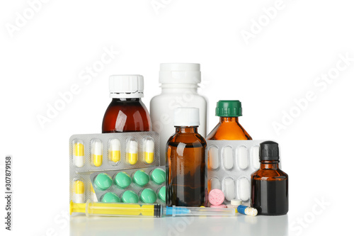 Medical bottles, syringe and pills isolated on white background
