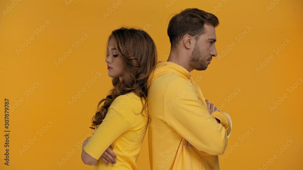 sad boyfriend and girlfriend hugging isolated on yellow sad boyfriend and girlfriend hugging isolated on yellow