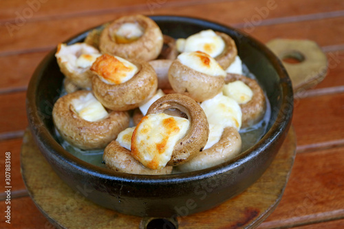 Fototapeta Naklejka Na Ścianę i Meble -  Soko Ketze or Georgian Stuffed Mushrooms with Sulguni Cheese Baked in a Ketsi Clay Dish