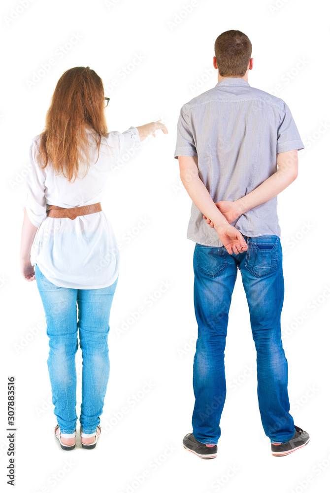Back view of a stylish couple pointing. Back view of a stylish couple pointing.