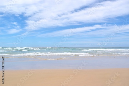 Sandy beach and dramatic waves in Gold Coast Australia.