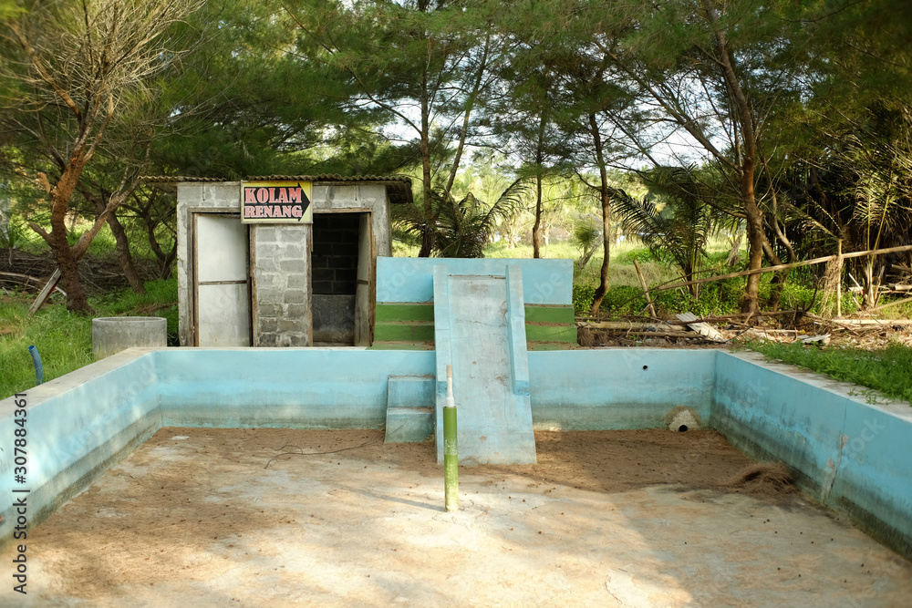 Yogyakarta, Indonesia, Feb 15, 2019. Modest swimming pool that is abandoned in the tourist area of Glagah Beach Yogyakarta, Indonesia, Feb 15, 2019. Modest swimming pool that is abandoned in the tourist area of Glagah Beach