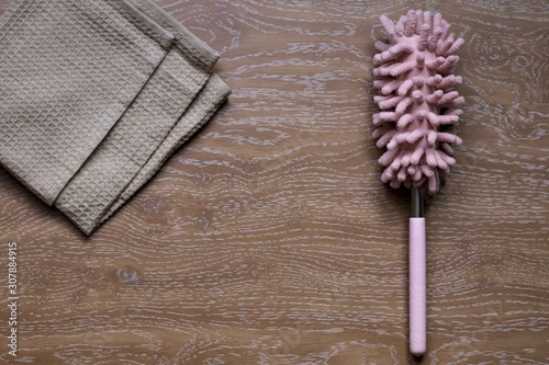 brush for cleaning dust, dirt in the house on a wooden background