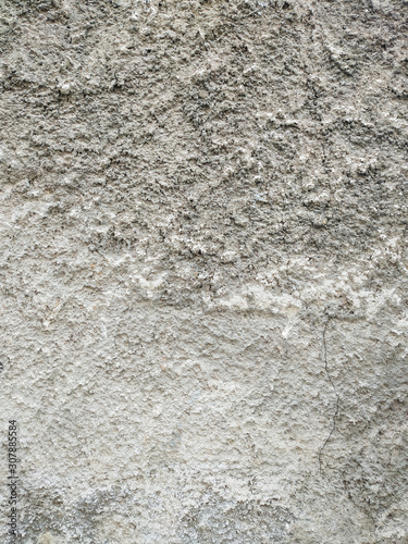 Rough texture of an old brown grey traditional wall with visible pattern of applying the cement and other materials wallpaper
