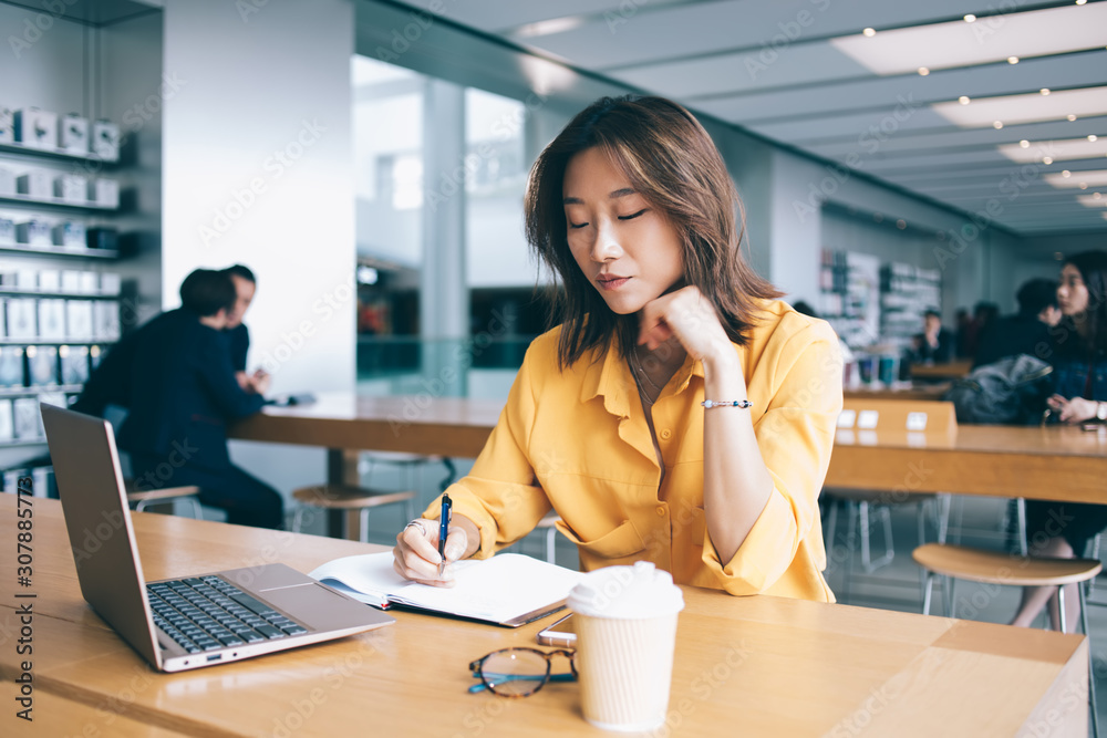 custom made wallpaper toronto digitalAsian woman writing in notebook at desk in cafe