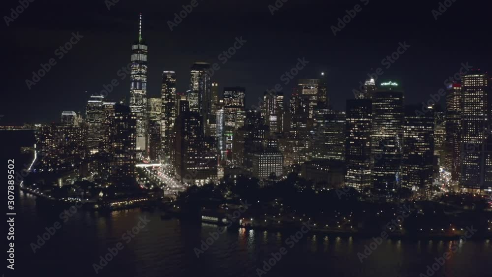 Aerial approach to night New York from the bay Aerial approach to night New York from the bay