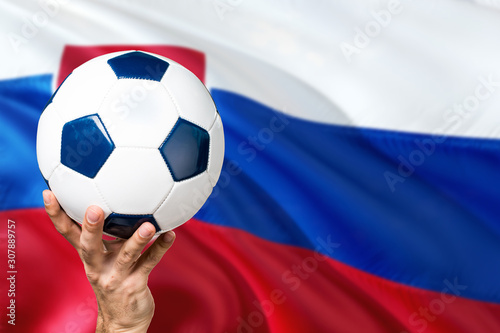 Slovakia soccer concept. National team player hand holding soccer ball with country flag background. Copy space for text.