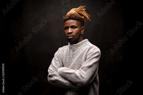 Valokuva Black man with blonde dreadlocks posing with crossed arms