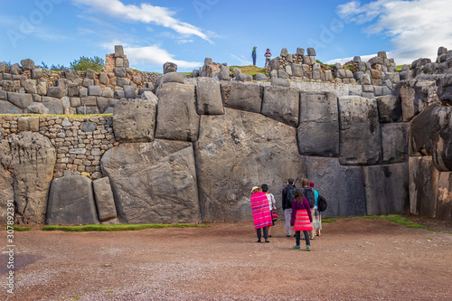 Saqsaywaman, Peru - Tourists Visiting Largest Inca Masonry Rock in the Wall at the Saqsaywaman Fortress outside Cuzco photo