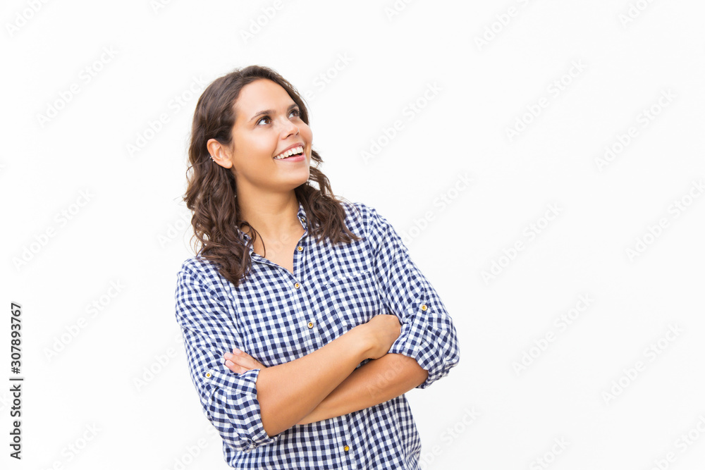 Happy surprised female customer staring up at copy space an laughing. Young woman in casual checked shirt standing isolated over white background. Promotion or special offer concept Happy surprised female customer staring up at copy space an laughing. Young woman in casual checked shirt standing isolated over white background. Promotion or special offer concept