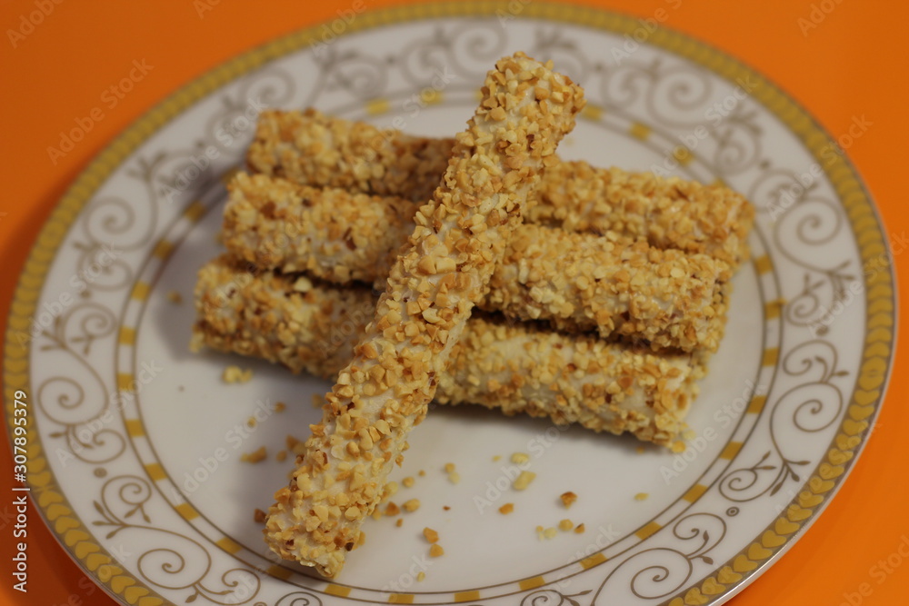tubes in nuts on a white plate tubes in nuts on a white plate