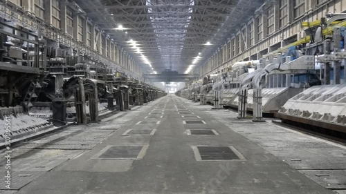 Contemporary large aluminum foundry with casting cells. Electrolytic baths in line in long workshop.
