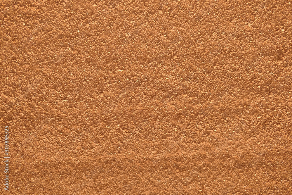 Fototapeta premium orange gravel sand baseball field background pattern closeup