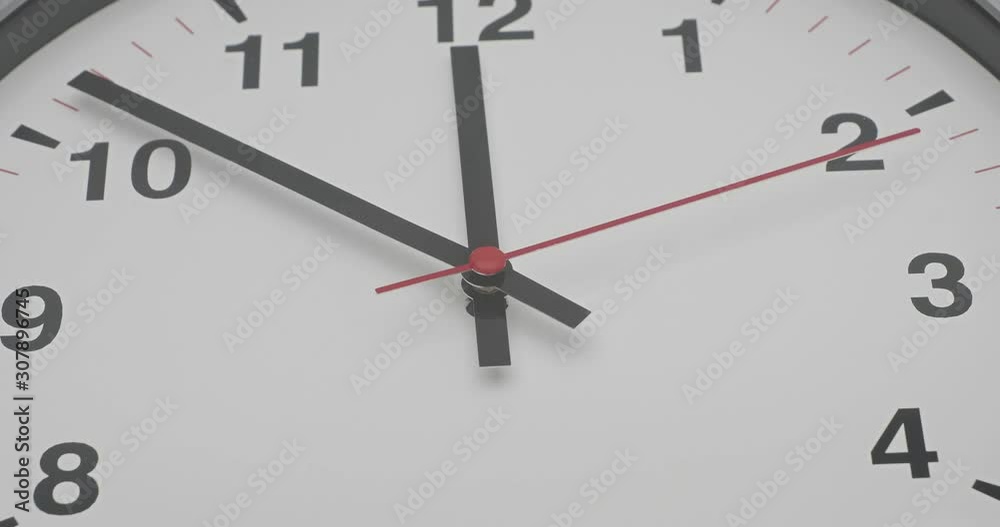 Truck shot of time-lapse gray clock with black arrows shows motion the time speed up from 10.00 and slow down to 12.00 , How time flies concept. Truck shot of time-lapse gray clock with black arrows shows motion the time speed up from 10.00 and slow down to 12.00 , How time flies concept.