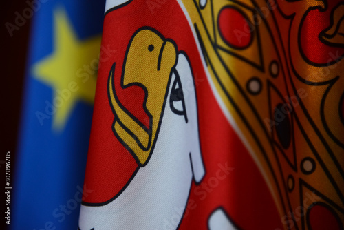  A central look at details of the Serbian flag with part of the European Union flag in bokeh