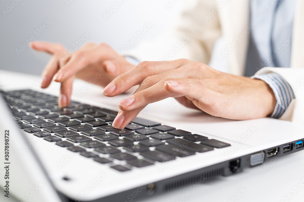 Man in business suit sitting at desk with laptop Man in business suit sitting at desk with laptop