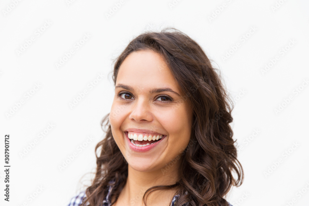 Closeup of broadly smiling student girl with white healthy teeth. Young woman in casual checked shirt standing isolated over white background. Female portrait concept Closeup of broadly smiling student girl with white healthy teeth. Young woman in casual checked shirt standing isolated over white background. Female portrait concept