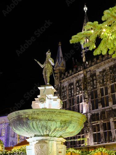 Illuminated Statue of Charlemagne sourrounded by the christmas market, created before 1900, in front of the Town Hall of Aachen, Germany
