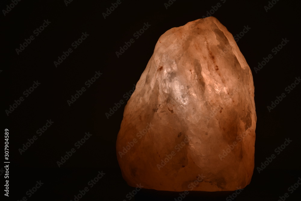 Obraz premium Himalaya Salt Lamp in the House Glowing in the Dark